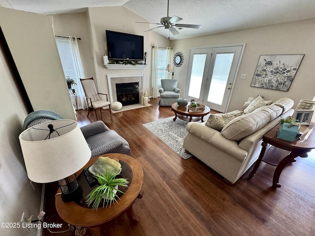 7520 Autumn Pointe Dr, Louisville, KY 40214 - living room with a ceiling fan, a tiled fireplace, wood finished floors, vaulted ceiling, and a textured ceiling