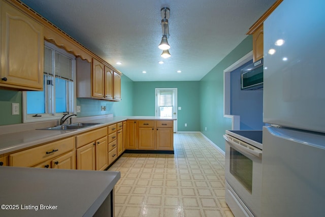 41 Raspberry Ct, Brandenburg, KY 40108 - kitchen with white appliances, light flooring, a peninsula, a textured ceiling, and light countertops