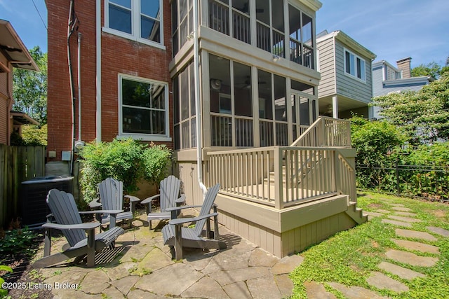 1211 Everett Ave, Louisville, KY 40204 - rear view of house with brick siding, a sunroom, and a patio area