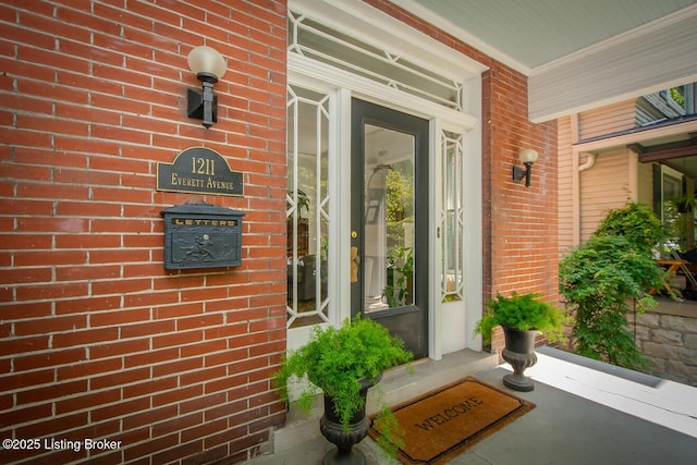 1211 Everett Ave, Louisville, KY 40204 - doorway to property featuring brick siding and a porch