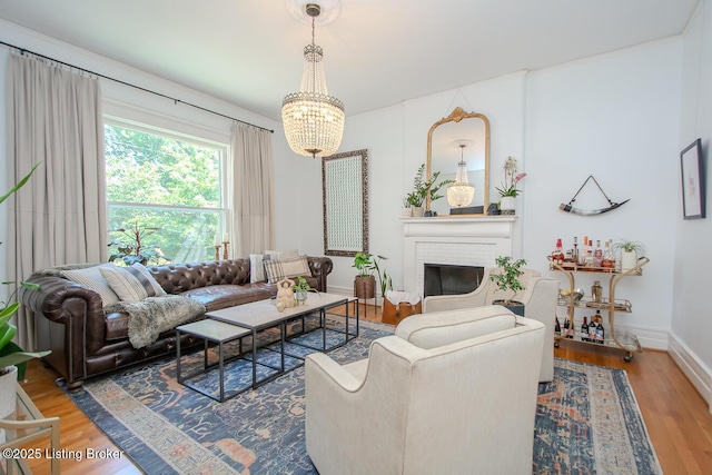 1211 Everett Ave, Louisville, KY 40204 - living room with a chandelier, wood finished floors, and a fireplace