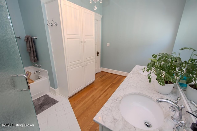 1211 Everett Ave, Louisville, KY 40204 - bathroom with a garden tub, double vanity, and wood finished floors
