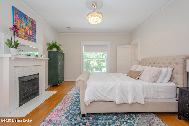 1211 Everett Ave, Louisville, KY 40204 - bedroom with wood finished floors, a fireplace, and crown molding