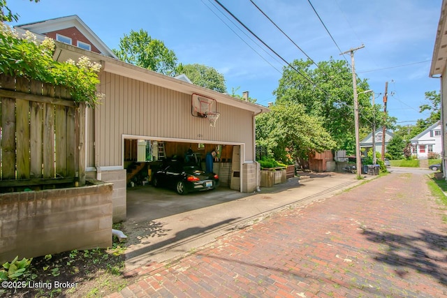 1211 Everett Ave, Louisville, KY 40204 - view of side of property featuring a garage, an outdoor structure, and driveway