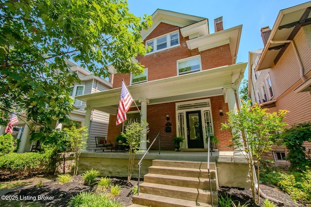 1211 Everett Ave, Louisville, KY 40204 - view of front facade featuring brick siding, covered porch, and a chimney