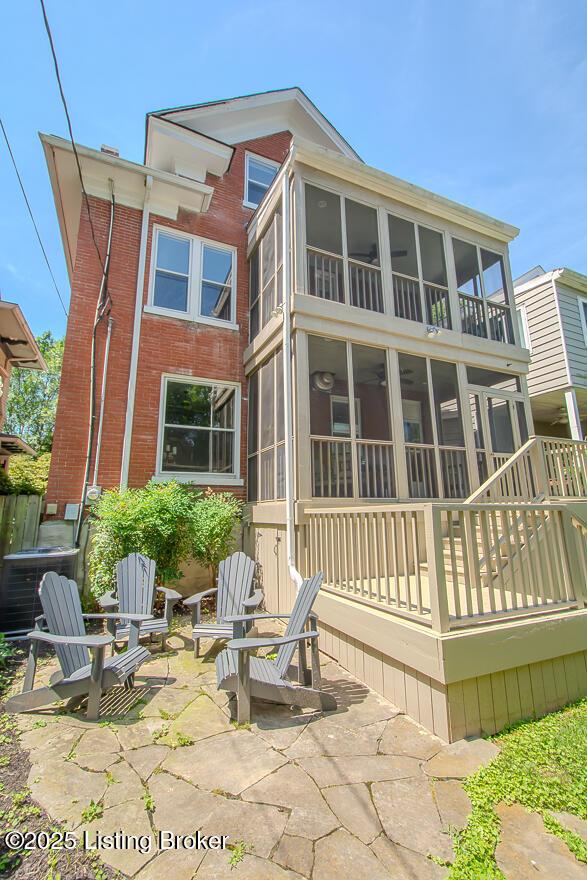 1211 Everett Ave, Louisville, KY 40204 - back of house with a sunroom, a patio, and brick siding