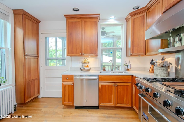 1211 Everett Ave, Louisville, KY 40204 - kitchen with stainless steel appliances, exhaust hood, radiator heating unit, plenty of natural light, and recessed lighting