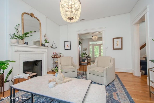 1211 Everett Ave, Louisville, KY 40204 - living area with wood finished floors, a chandelier, and a fireplace