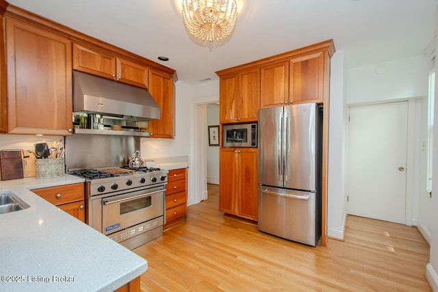 1211 Everett Ave, Louisville, KY 40204 - kitchen with stainless steel appliances, extractor fan, light countertops, and a chandelier