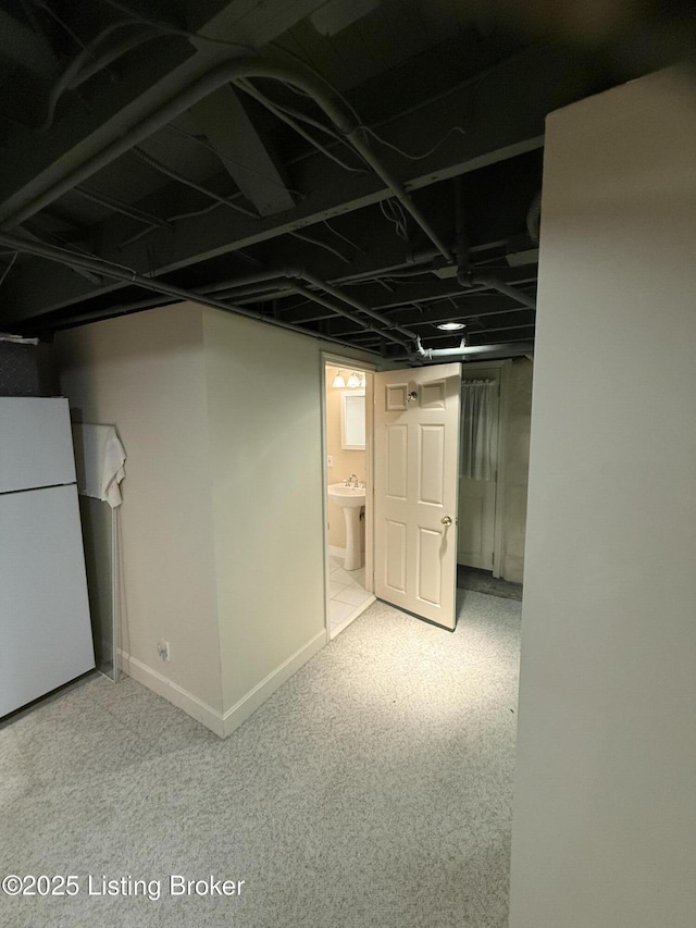 1211 Everett Ave, Louisville, KY 40204 - finished below grade area with freestanding refrigerator and carpet flooring