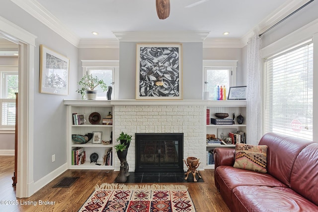 1700 Shady Ln, Louisville, KY 40205 - living area featuring wood finished floors, healthy amount of natural light, a fireplace, ornamental molding, and recessed lighting