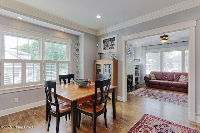 1700 Shady Ln, Louisville, KY 40205 - dining area featuring healthy amount of natural light, ornamental molding, wood finished floors, a fireplace, and ceiling fan