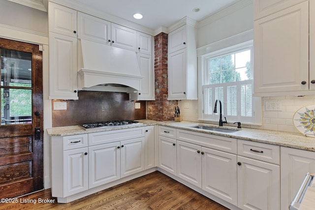 1700 Shady Ln, Louisville, KY 40205 - kitchen with stainless steel gas cooktop, white cabinets, premium range hood, light stone counters, and recessed lighting