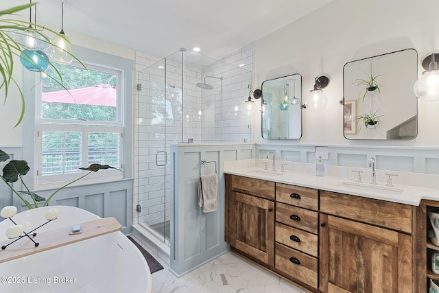 1700 Shady Ln, Louisville, KY 40205 - bathroom with a shower stall, double vanity, a decorative wall, a freestanding bath, and a wainscoted wall