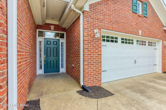14518 Lake Village Dr Unit 4B, Louisville, KY 40299 - property entrance featuring brick siding, concrete driveway, and an attached garage