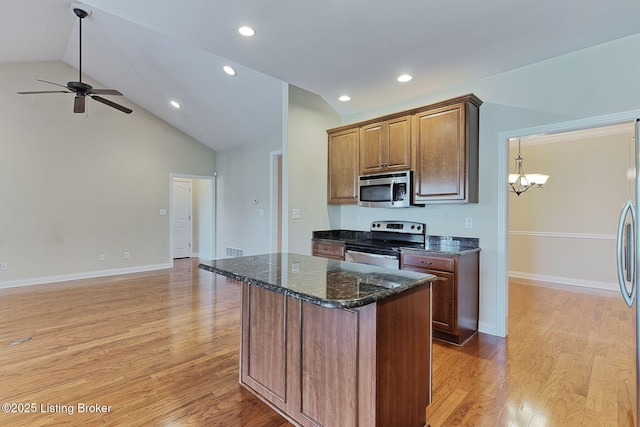 14518 Lake Village Dr Unit 4B, Louisville, KY 40299 - kitchen featuring stainless steel appliances, lofted ceiling, a ceiling fan, light wood-type flooring, and a chandelier