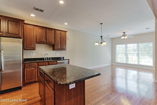 14518 Lake Village Dr Unit 4B, Louisville, KY 40299 - kitchen featuring stainless steel appliances, light wood-style flooring, ceiling fan, a center island, and recessed lighting