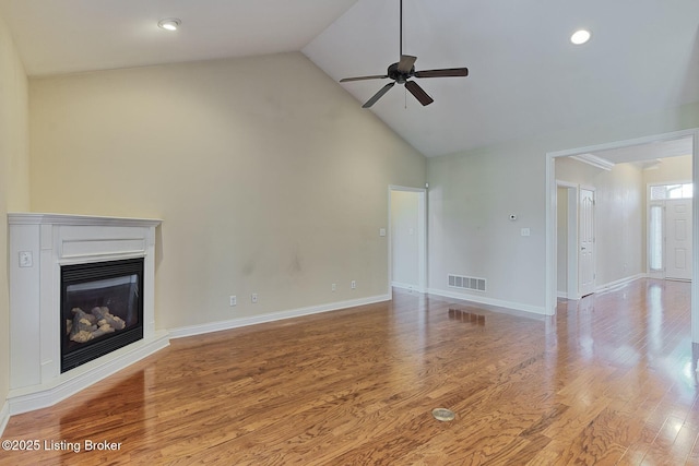 14518 Lake Village Dr Unit 4B, Louisville, KY 40299 - unfurnished living room with a ceiling fan, a glass covered fireplace, wood finished floors, high vaulted ceiling, and recessed lighting