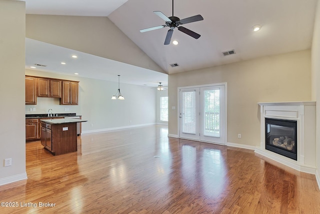 14518 Lake Village Dr Unit 4B, Louisville, KY 40299 - unfurnished living room featuring ceiling fan, high vaulted ceiling, a glass covered fireplace, light wood-style floors, and recessed lighting
