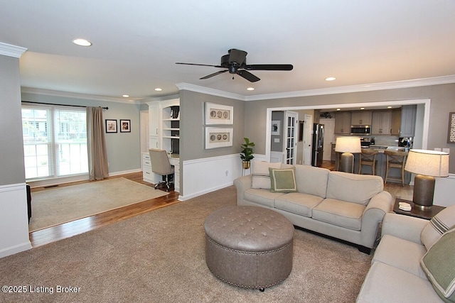 4201 Patterson Park Ct, Louisville, KY 40299 - carpeted living room with recessed lighting, ornamental molding, ceiling fan, a desk, and wood finished floors