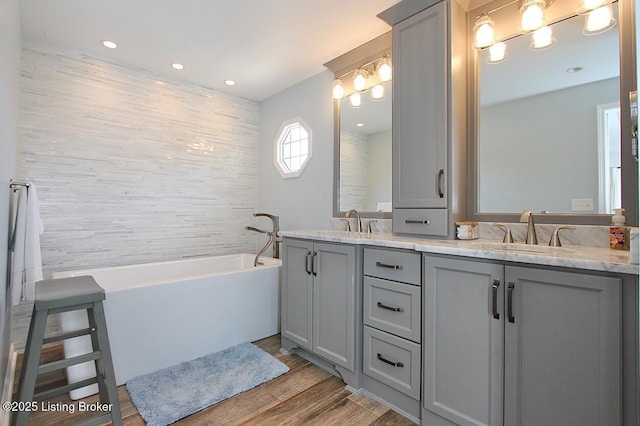 4201 Patterson Park Ct, Louisville, KY 40299 - bathroom with a tub to relax in, double vanity, wood finished floors, and recessed lighting