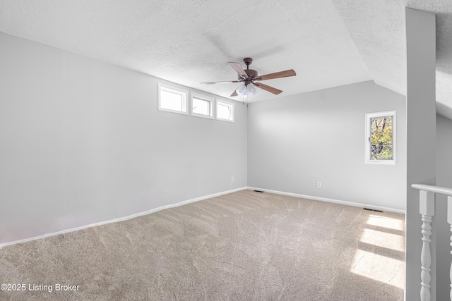 1128 Cherokee Rd Apt 1A, Louisville, KY 40204 - carpeted empty room featuring ceiling fan, a textured ceiling, and lofted ceiling