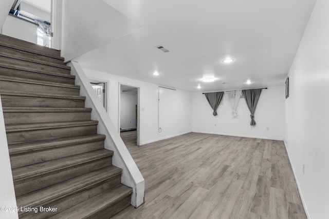 6206 Tabor Dr, Louisville, KY 40218 - finished below grade area with stairway, light wood-style floors, and recessed lighting