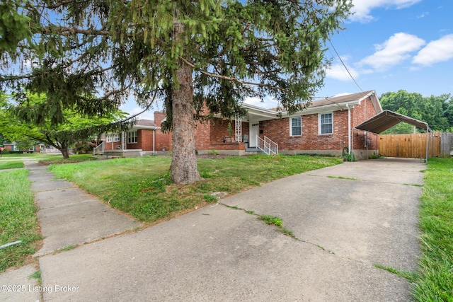 6206 Tabor Dr, Louisville, KY 40218 - single story home with brick siding, concrete driveway, a detached carport, and a porch