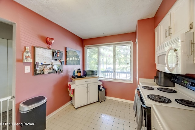 9315 Loch Lea Ln Unit B, Louisville, KY 40291 - kitchen with electric range, white microwave, white cabinets, light floors, and light countertops