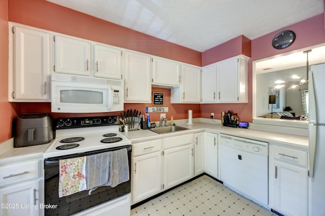 9315 Loch Lea Ln Unit B, Louisville, KY 40291 - kitchen featuring white appliances, white cabinets, light countertops, light floors, and a textured ceiling