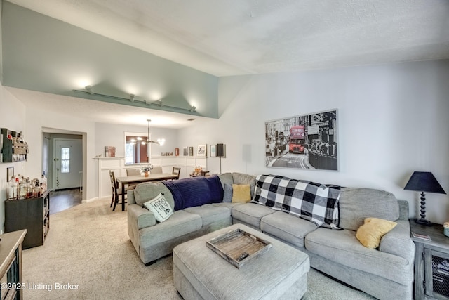 9315 Loch Lea Ln Unit B, Louisville, KY 40291 - living room featuring a chandelier, vaulted ceiling, and light colored carpet