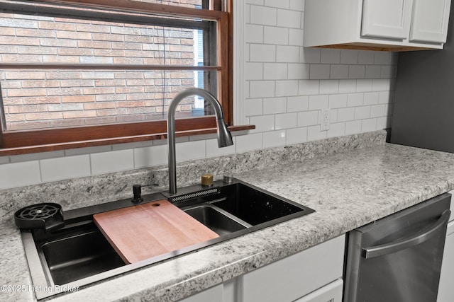 3322 Virginia Ave, Louisville, KY 40211 - kitchen with dishwasher, tasteful backsplash, light countertops, and white cabinetry