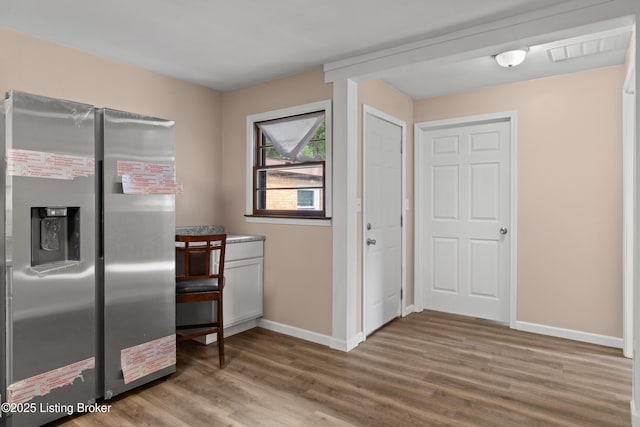 3322 Virginia Ave, Louisville, KY 40211 - kitchen with stainless steel fridge with ice dispenser and wood finished floors