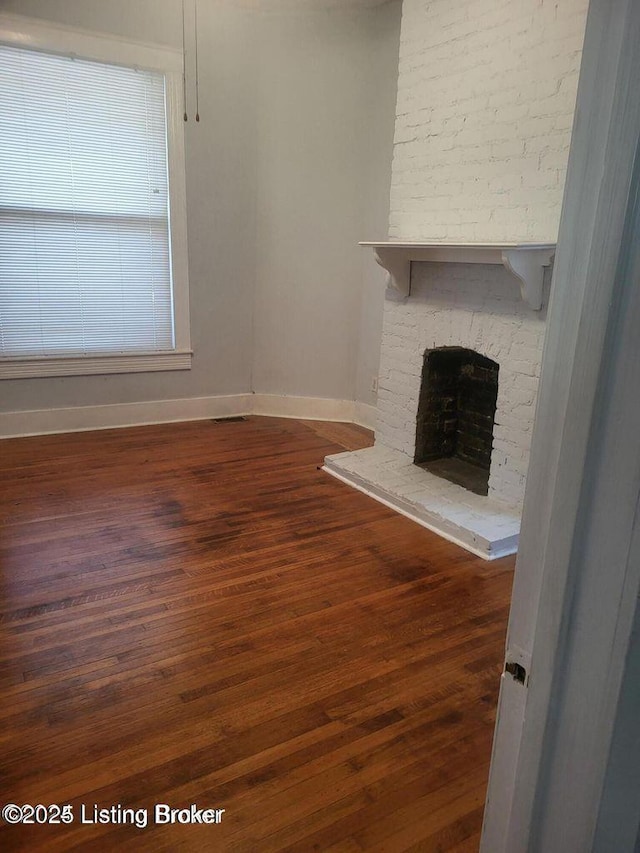 114 S Bayly Ave, Louisville, KY 40206 - unfurnished living room featuring a fireplace and wood finished floors