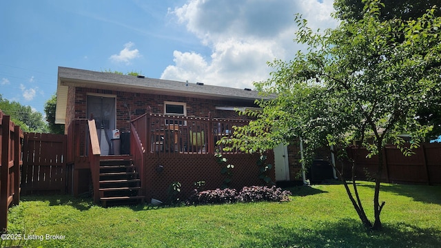 609 E Main St, Vine Grove, KY 40175 - rear view of house featuring a fenced backyard, a wooden deck, brick siding, and stairway