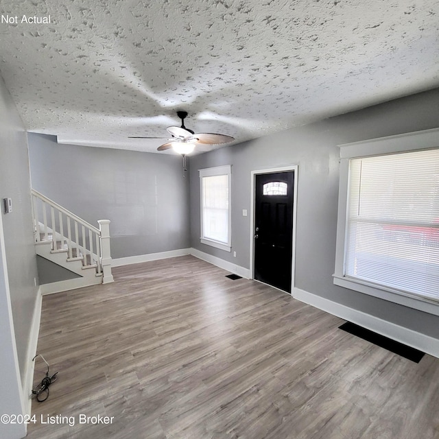 1412 Beech St, Louisville, KY 40211 - entrance foyer with stairs, wood finished floors, ceiling fan, and a textured ceiling