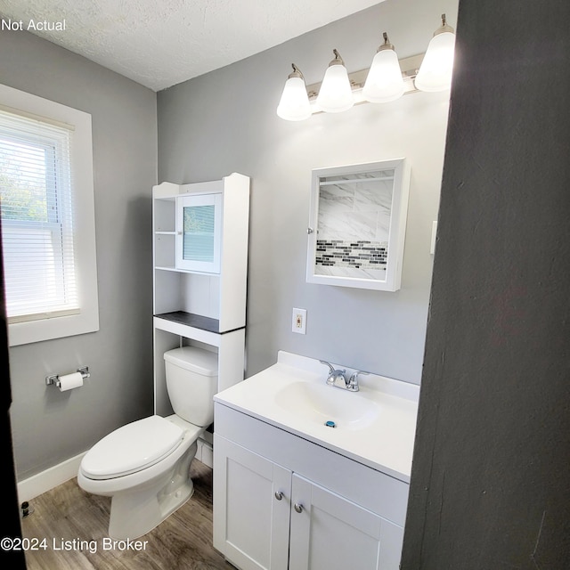 1412 Beech St, Louisville, KY 40211 - half bathroom with wood finished floors, vanity, and a textured ceiling