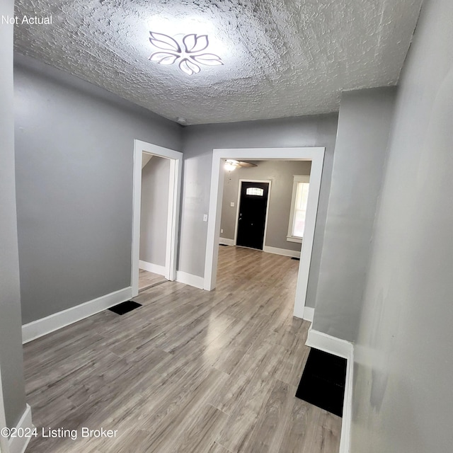 1412 Beech St, Louisville, KY 40211 - hallway with wood finished floors and a textured ceiling