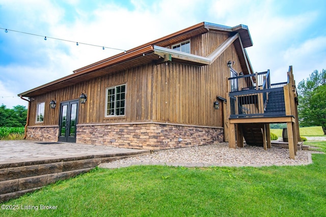 650 Midway Rd, Guston, KY 40142 - view of side of home with french doors, a lawn, a deck, and stone siding