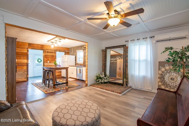 650 Midway Rd, Guston, KY 40142 - living room with a wall mounted AC, wood finished floors, ceiling fan, and wood walls