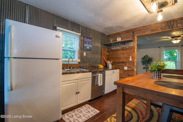 650 Midway Rd, Guston, KY 40142 - kitchen featuring freestanding refrigerator, dishwasher, healthy amount of natural light, white cabinets, and wood walls