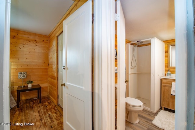 650 Midway Rd, Guston, KY 40142 - full bathroom featuring wood finished floors, a stall shower, vanity, and wood walls