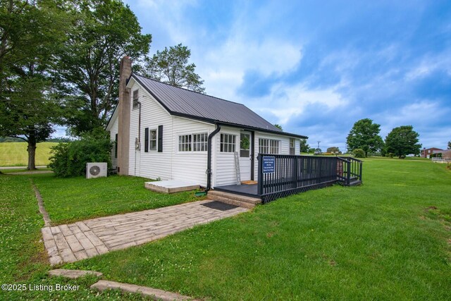 650 Midway Rd, Guston, KY 40142 - view of front facade featuring a chimney, a front lawn, a metal roof, and a wooden deck