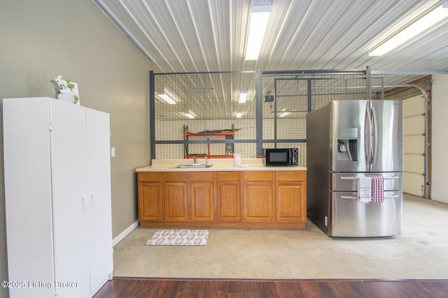 650 Midway Rd, Guston, KY 40142 - kitchen with stainless steel fridge with ice dispenser, black microwave, brown cabinets, and light countertops