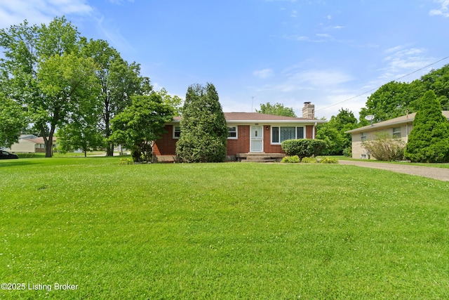 8703 Fernview Dr, Louisville, KY 40291 - view of front of home featuring brick siding, a chimney, and a front yard