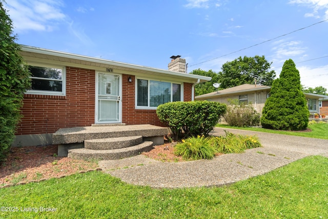8703 Fernview Dr, Louisville, KY 40291 - view of front of home featuring brick siding and a chimney