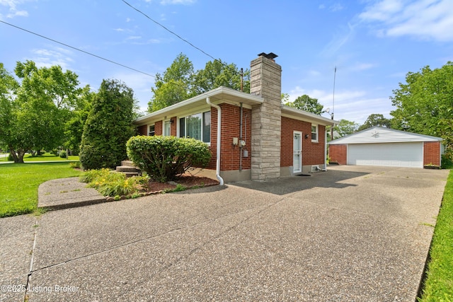 8703 Fernview Dr, Louisville, KY 40291 - view of side of home featuring brick siding, a detached garage, a chimney, an outbuilding, and a lawn