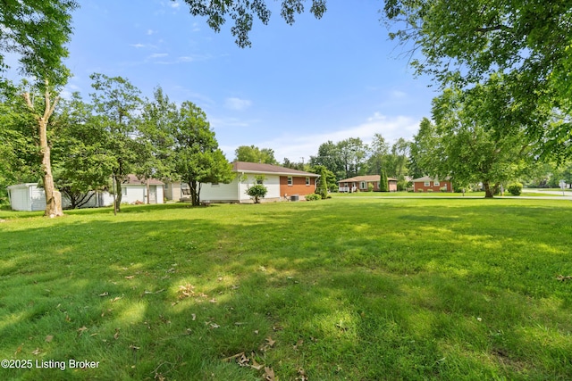 8703 Fernview Dr, Louisville, KY 40291 - view of green lawn featuring a storage shed