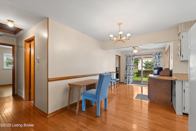 8703 Fernview Dr, Louisville, KY 40291 - dining room featuring light wood finished floors, a chandelier, a ceiling fan, and wainscoting