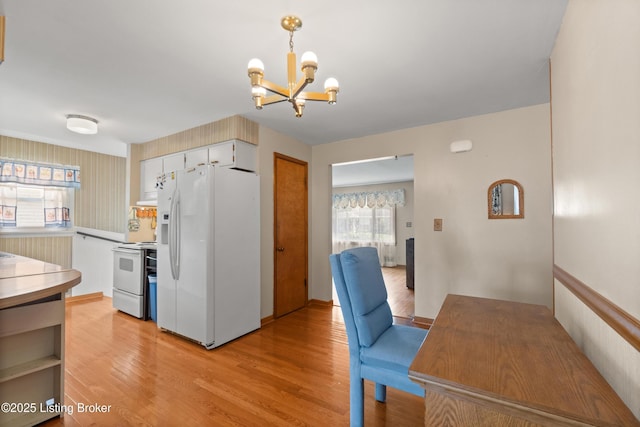 8703 Fernview Dr, Louisville, KY 40291 - kitchen with white appliances, a chandelier, light wood finished floors, and decorative light fixtures